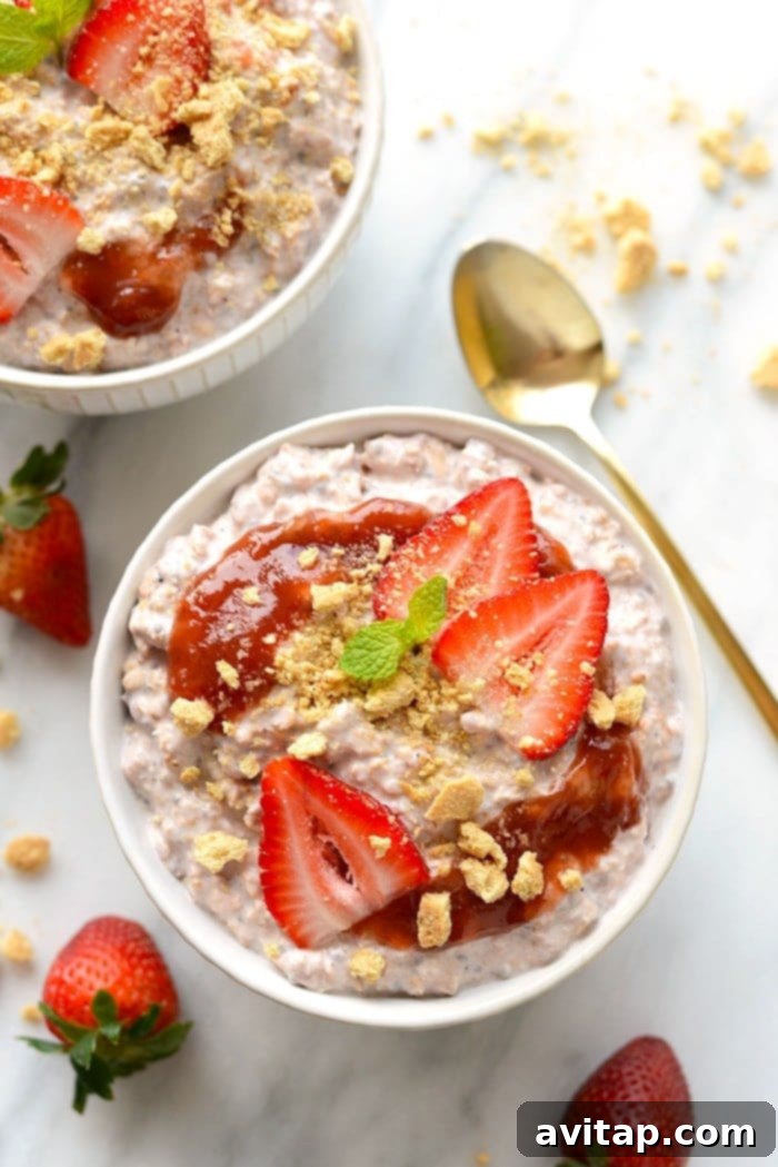 Ready-to-Eat Strawberry Overnight Oats with Toppings A close-up of creamy strawberry overnight oats in a bowl, garnished with fresh whole strawberries.
