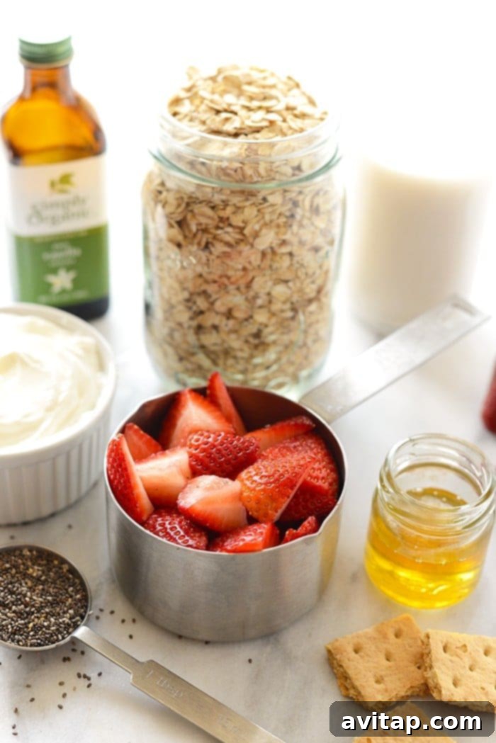 Key Ingredients for Strawberry Cheesecake Overnight Oats Essential ingredients for strawberry cheesecake overnight oats laid out on a kitchen countertop.