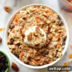 No-Bake Carrot Cake Oats 5 A beautifully presented bowl of carrot cake overnight oats, topped with a swirl of creamy yogurt and a dusting of cinnamon, inviting readers to prepare this delicious breakfast.