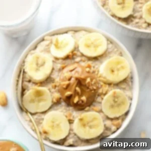 A bowl of creamy overnight oats with peanut butter and banana slices, ready to eat.