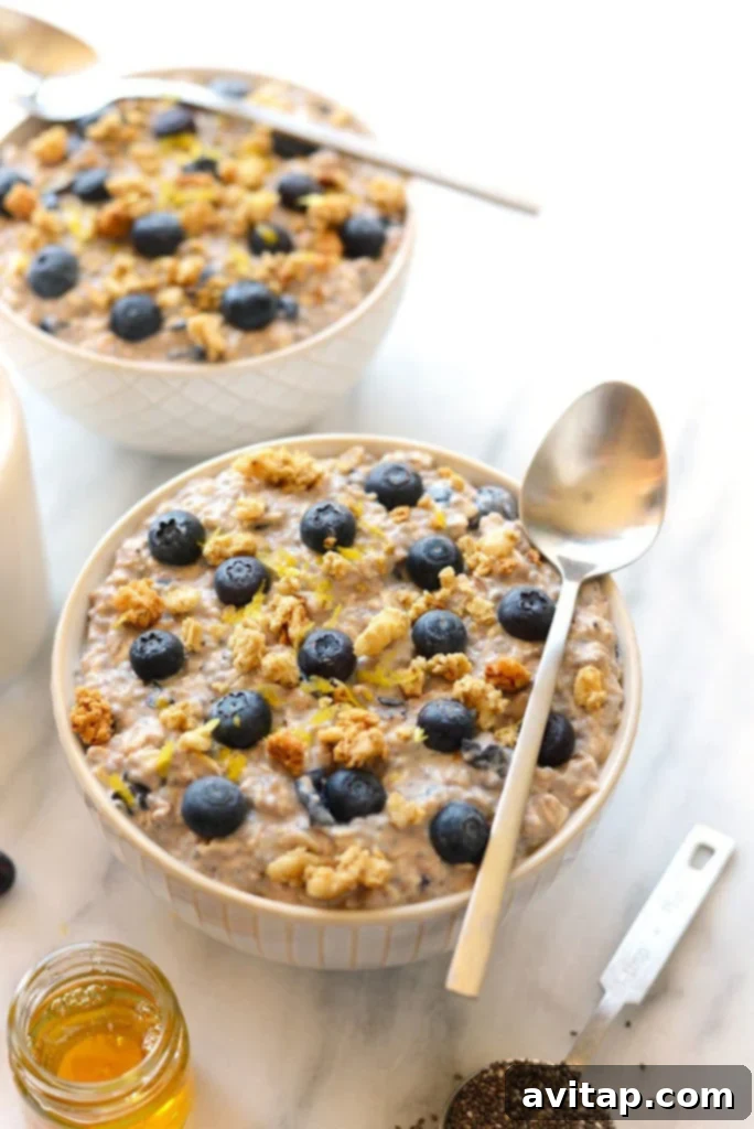Start your day right with these healthy Blueberry Overnight Oats, packed with blueberry muffin flavor! Creamy blueberry overnight oats in a glass bowl, garnished with fresh blueberries and lemon zest