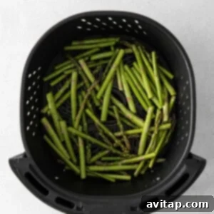 Crispy Air Fryer Asparagus 11 Perfectly cooked asparagus in the air fryer basket.