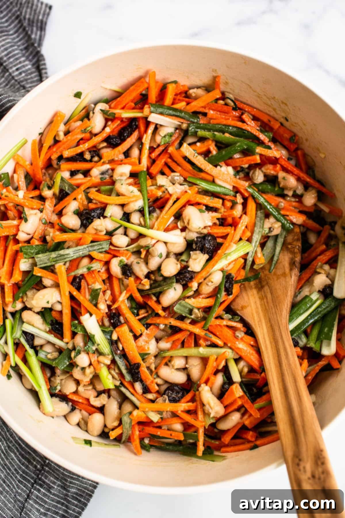 Vibrant French Carrot Salad, beautifully plated in a serving bowl, showcasing its diverse textures and colors.