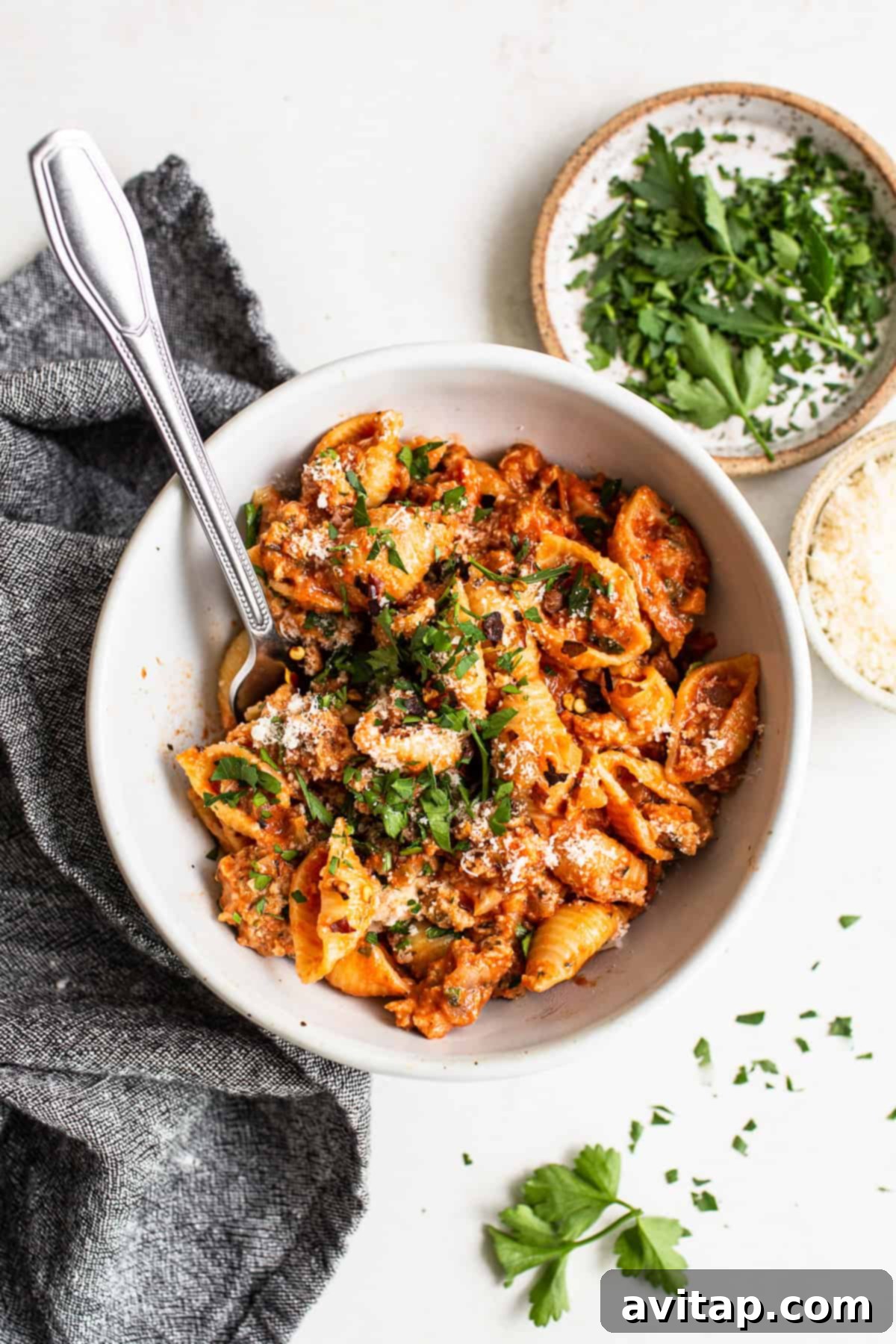 Ground Turkey Pasta in a Bowl A bowl of ground turkey pasta with parmesan and parsley.