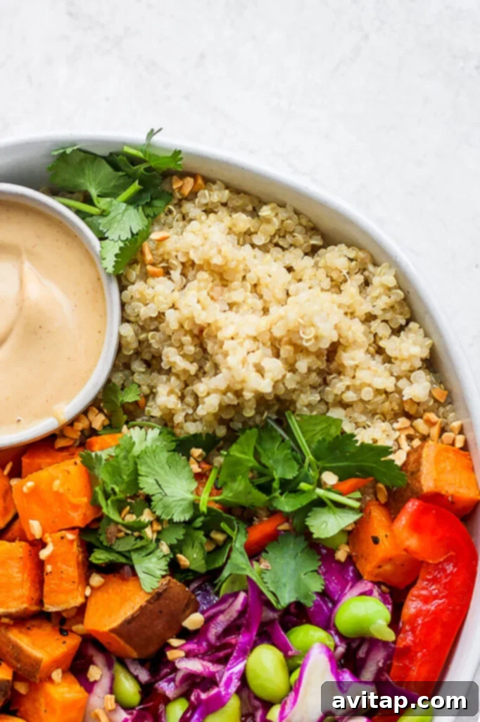 Island Coconut Quinoa 2 A beautifully presented bowl of creamy coconut quinoa salad, garnished with fresh herbs and a side dipping sauce.