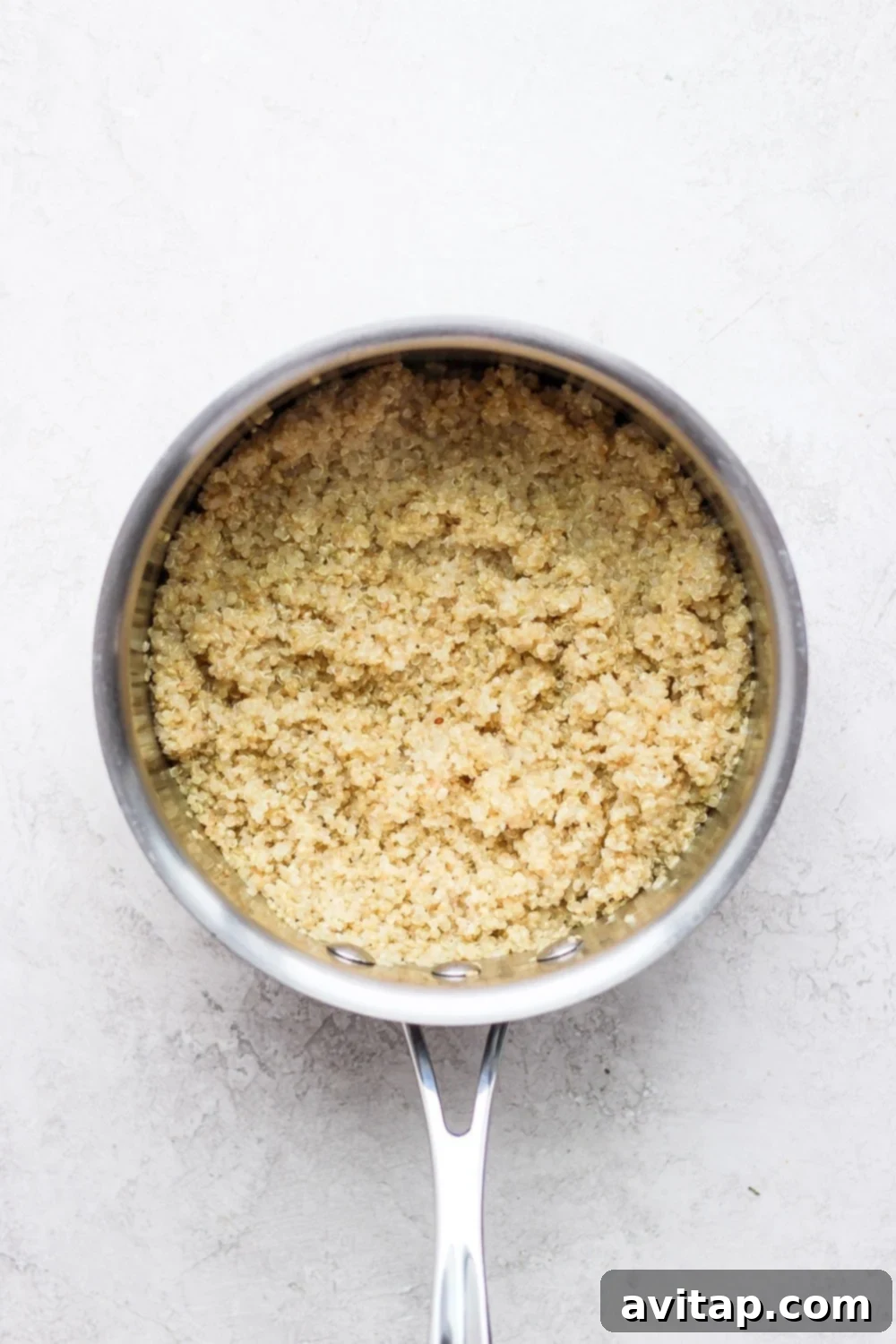 Island Coconut Quinoa 5 A perfectly cooked batch of fluffy coconut quinoa in a saucepan, ready to be served or incorporated into various dishes.