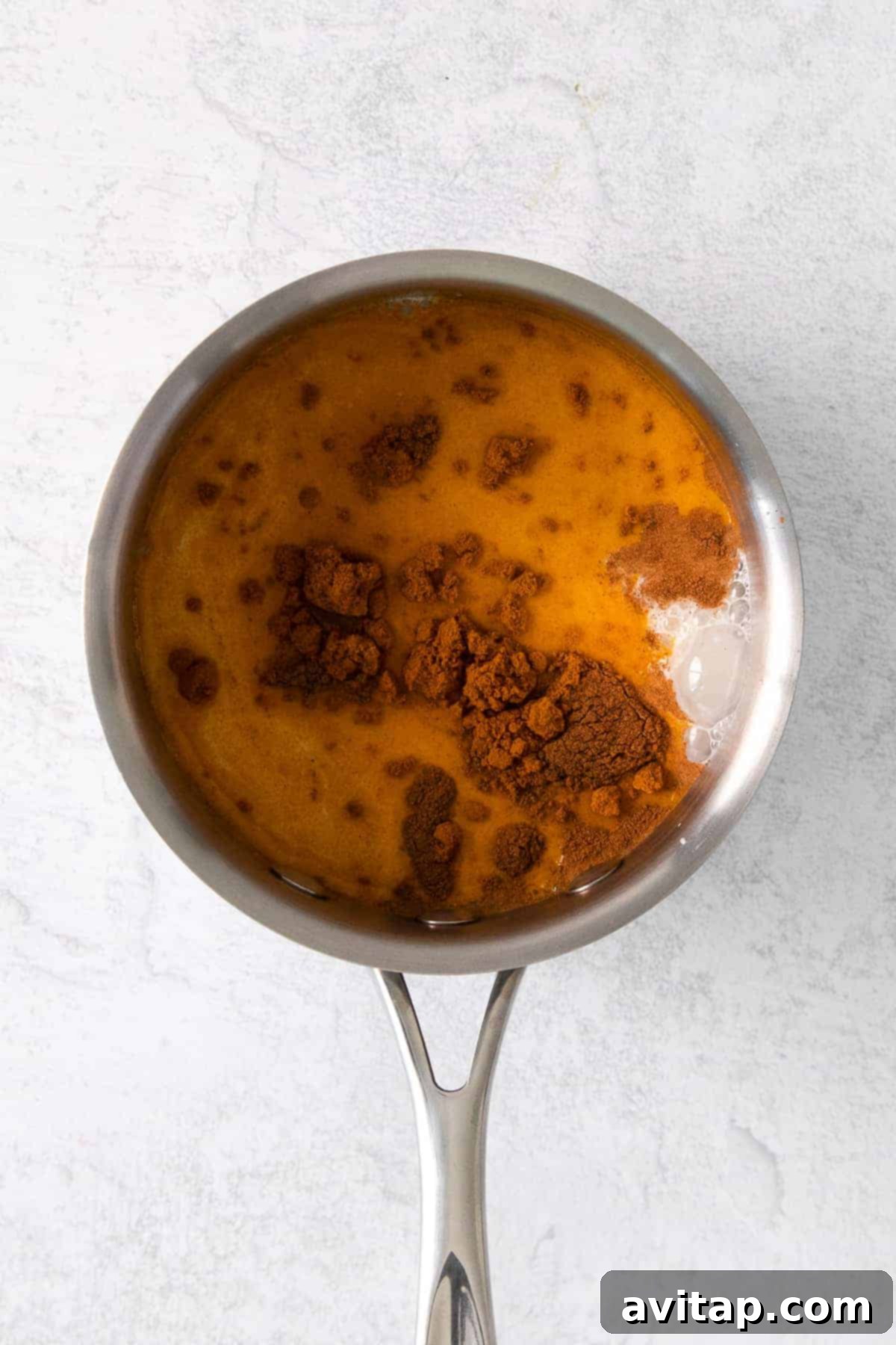 Golden milk latte simmering in a pot