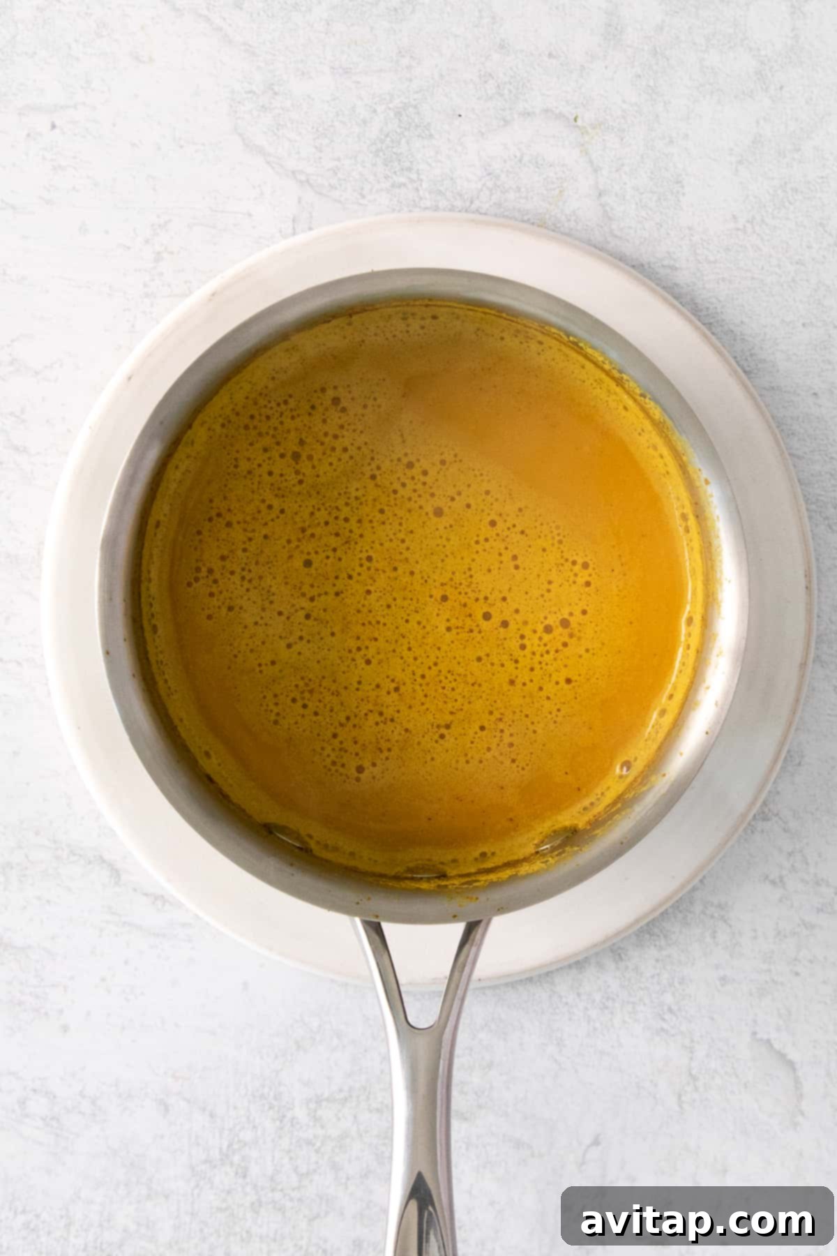 A mug of golden milk latte, steaming gently