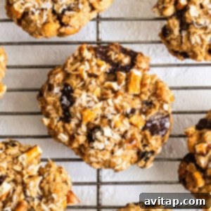 A close-up of a stack of delicious kitchen sink cookies with various toppings.