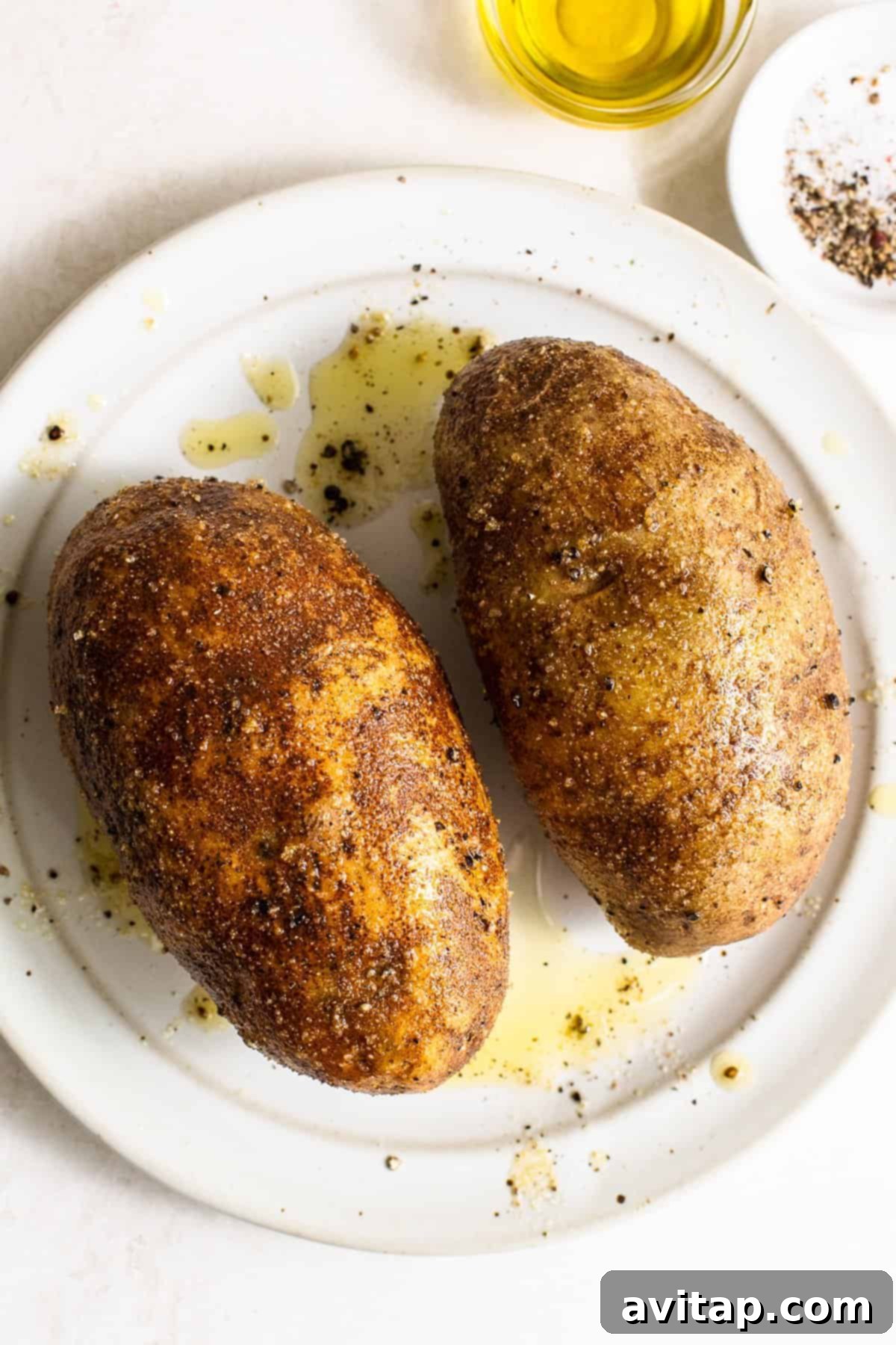 Russet potatoes with olive oil, salt, and pepper ready for air frying