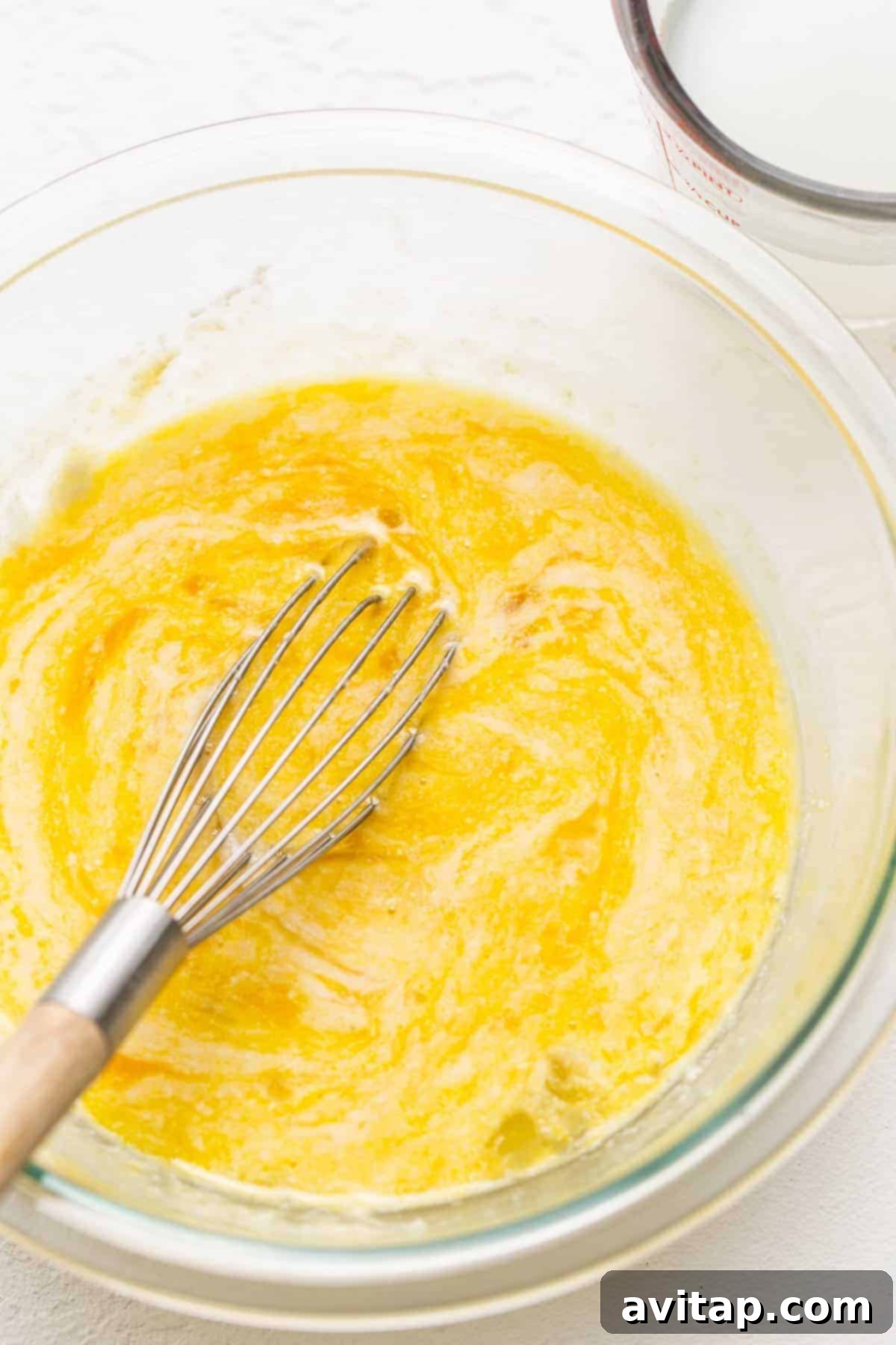 Close-up of whisked eggs in a bowl, prepared for making chicken carbonara.
