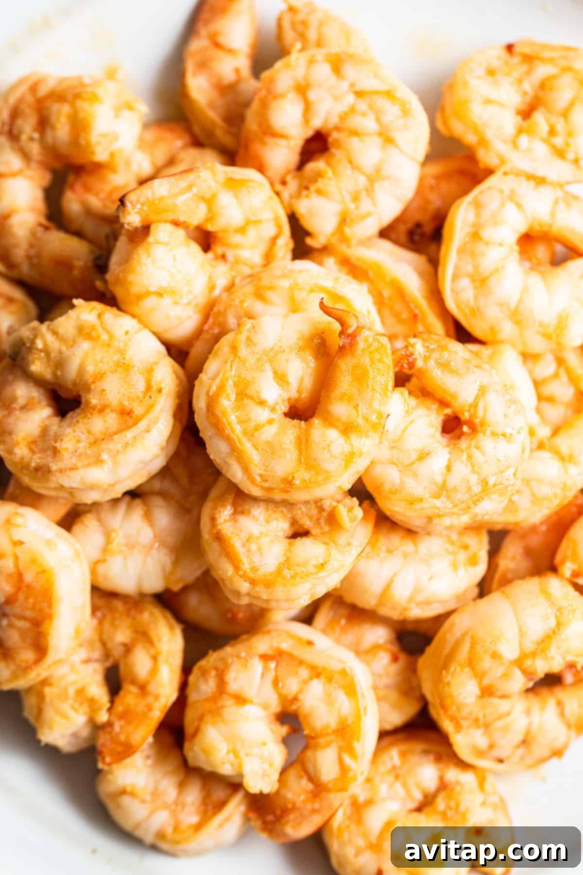 Perfectly cooked, succulent shrimp, golden-brown and ready to be added back into the fried rice.