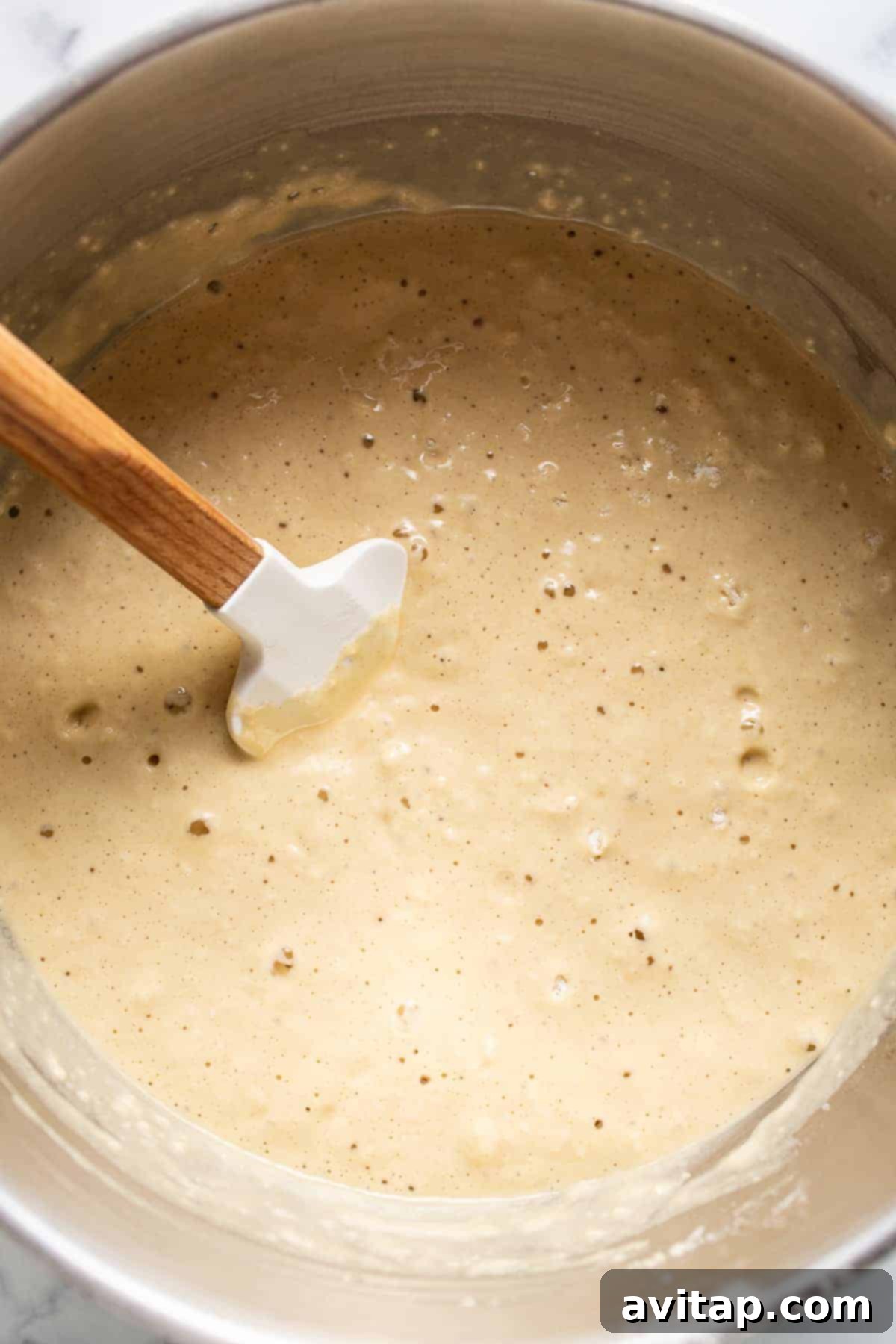 Pancake batter in a large mixing bowl, showing its creamy texture and readiness for cooking
