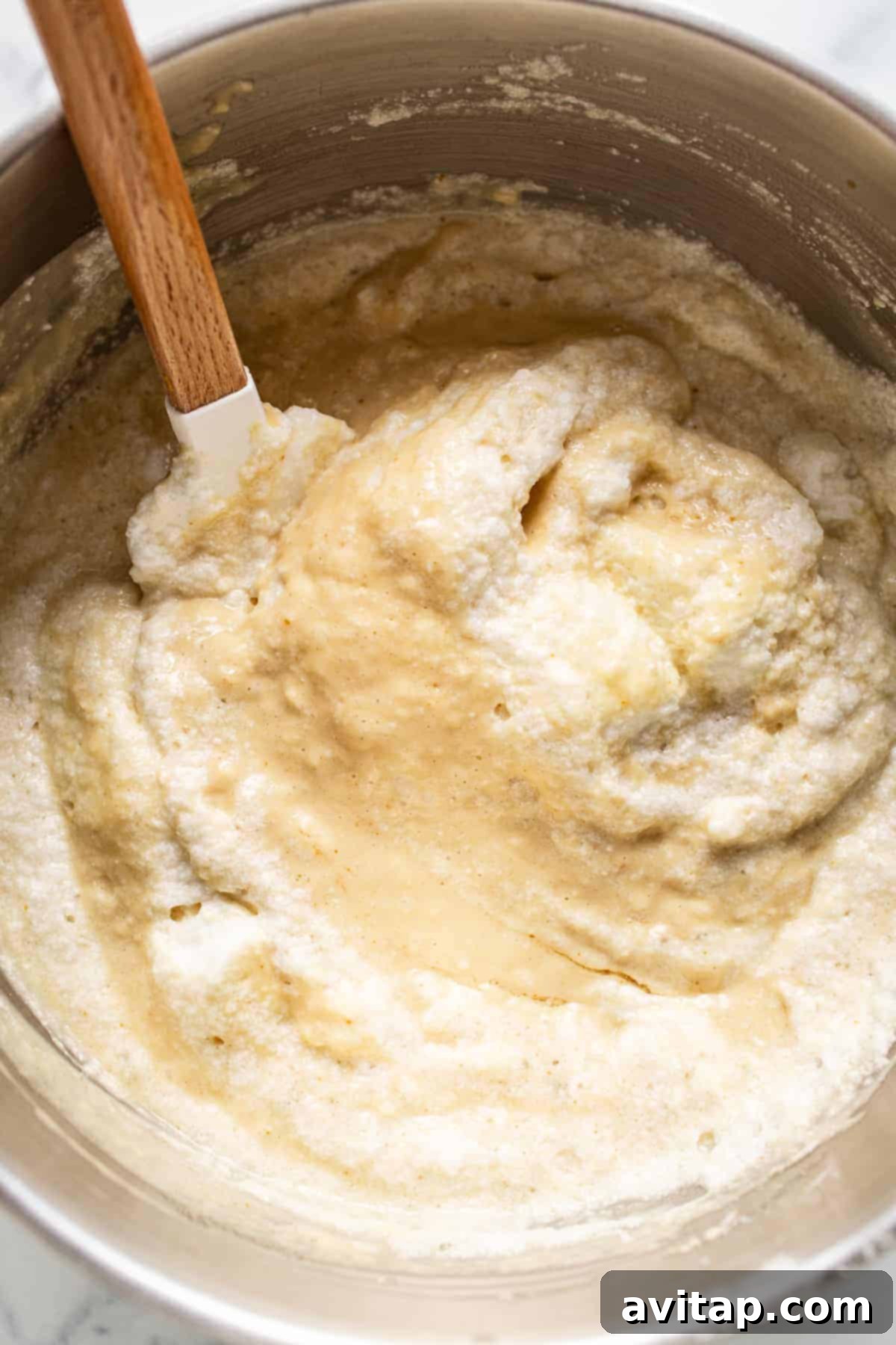 Fluffy egg whites gently folded into rich brown butter pancake batter, showcasing the light texture
