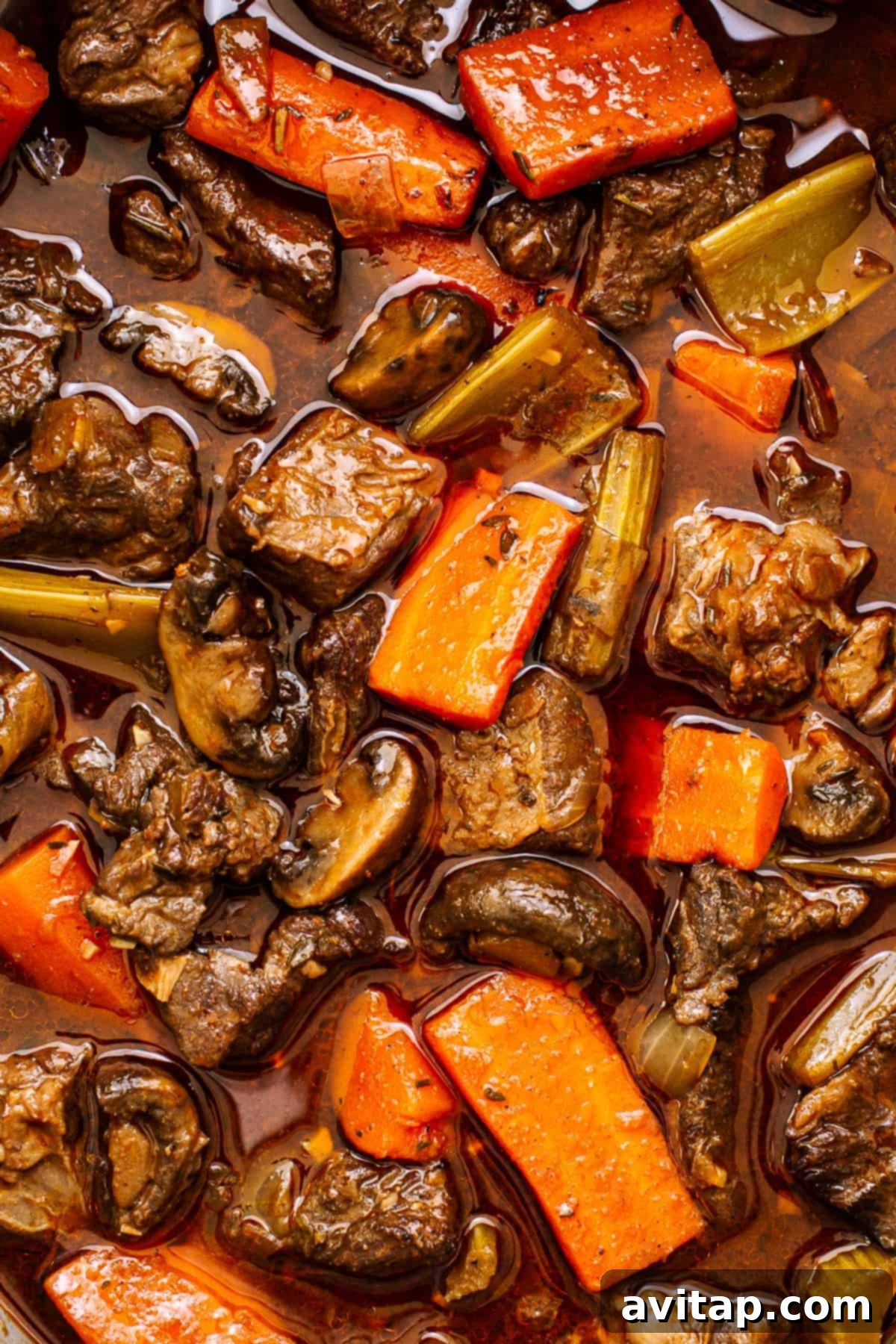 Guinness Beef stew simmering gently in a Dutch oven.
