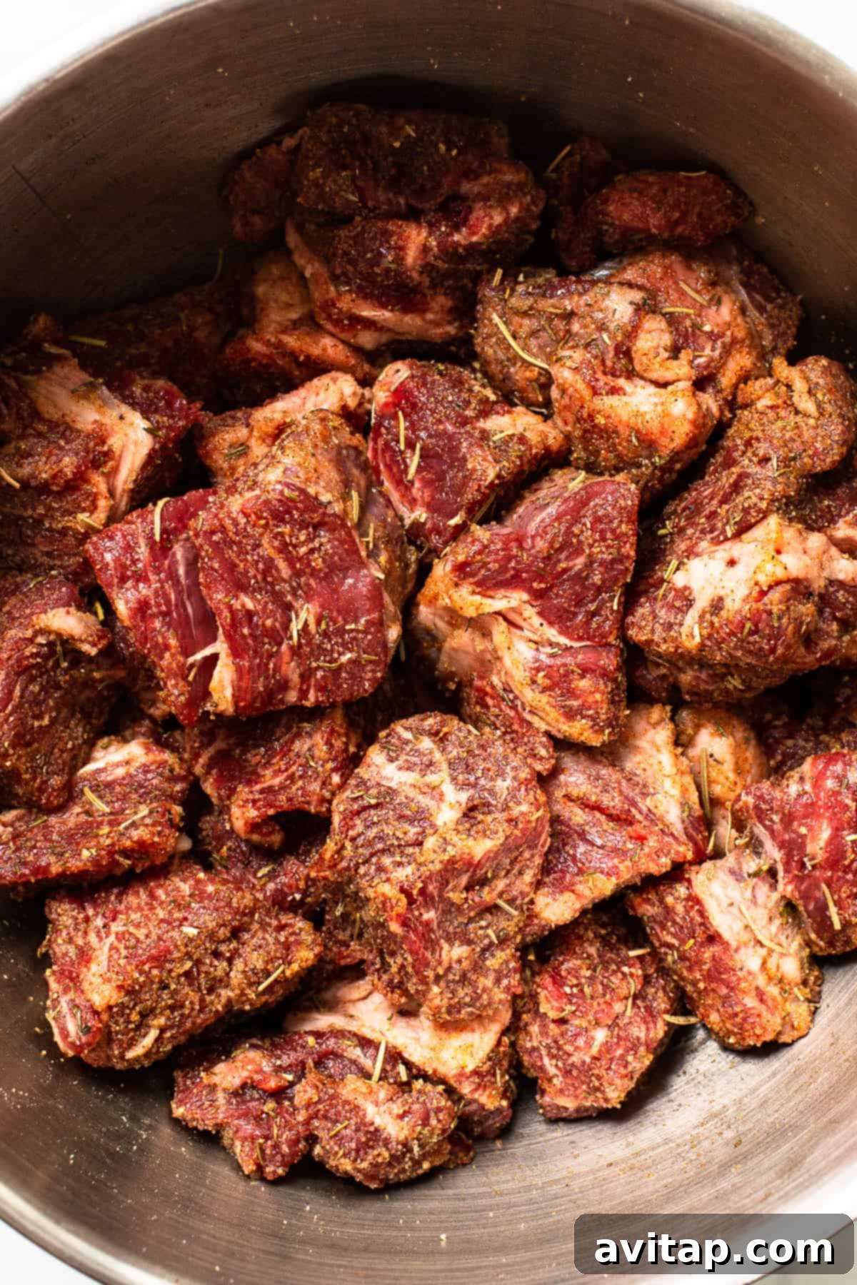 Seared beef chuck roast pieces in a Dutch oven, ready for stewing.