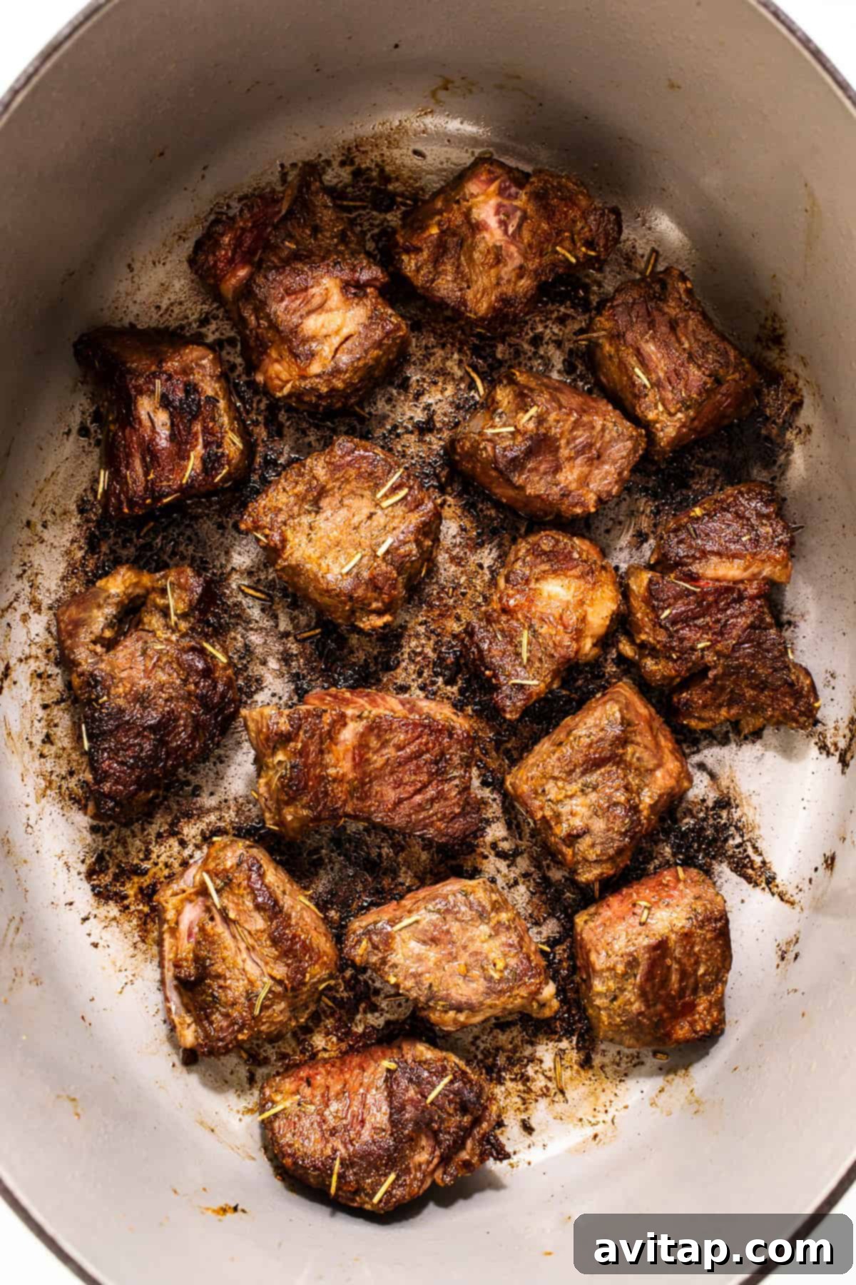 Perfectly browned beef chunks in a pot, adding depth to the stew.