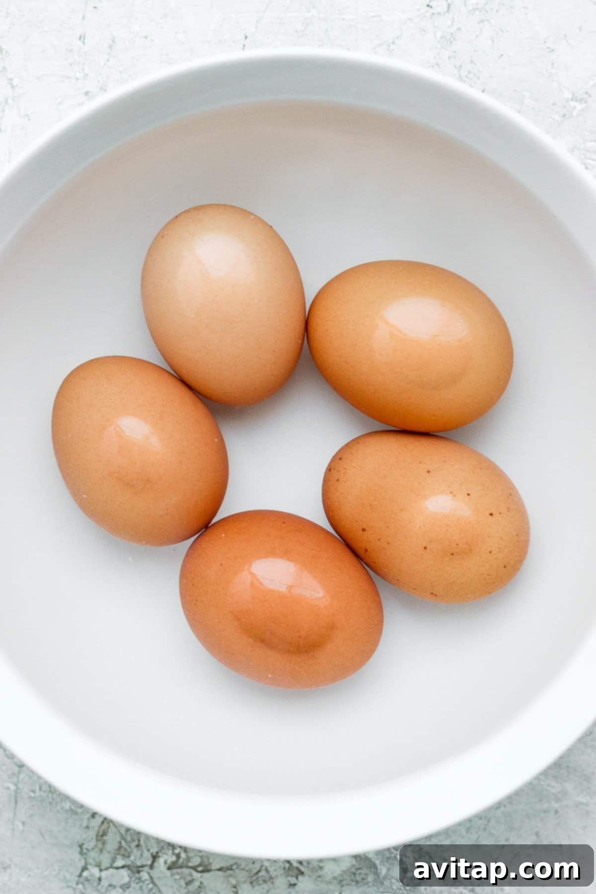 Eggs gently cooking in a water bath, ready to be boiled for the salad.