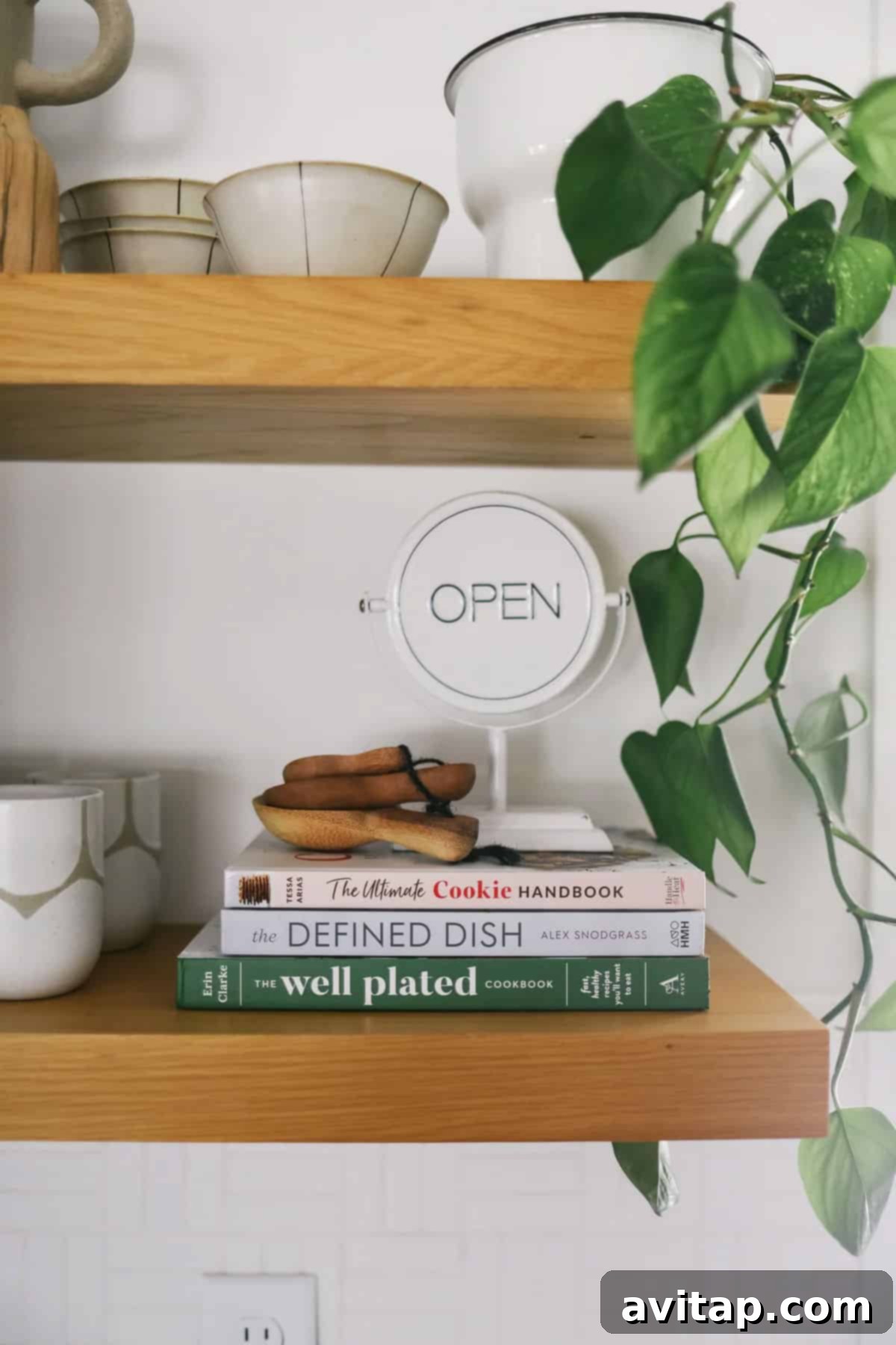 Elegant white oak floating shelves showcasing kitchen decor, adding warmth and open storage to the Scandinavian Modern kitchen.