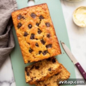 A freshly baked loaf of pancake mix banana bread cooling on a wire rack.