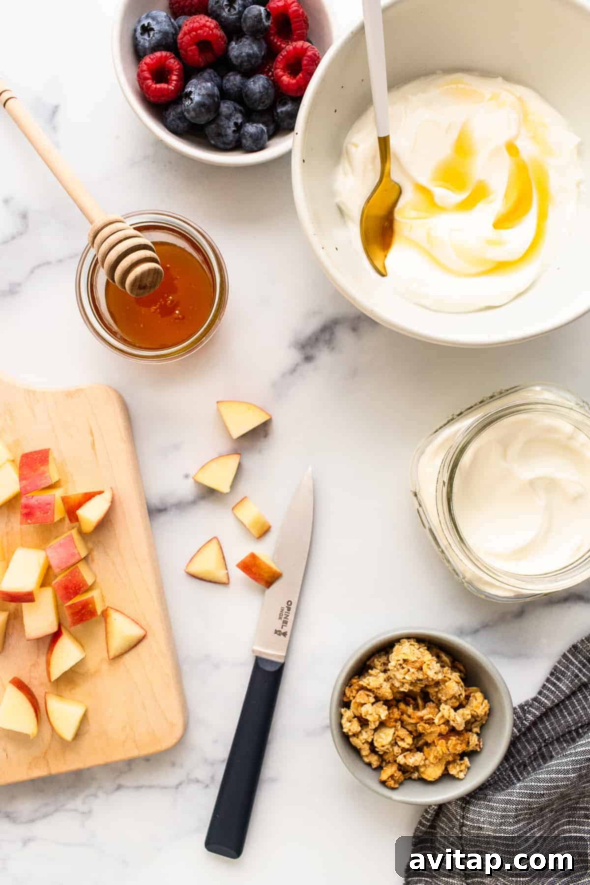 Ingredients for a yogurt parfait displayed in bowls