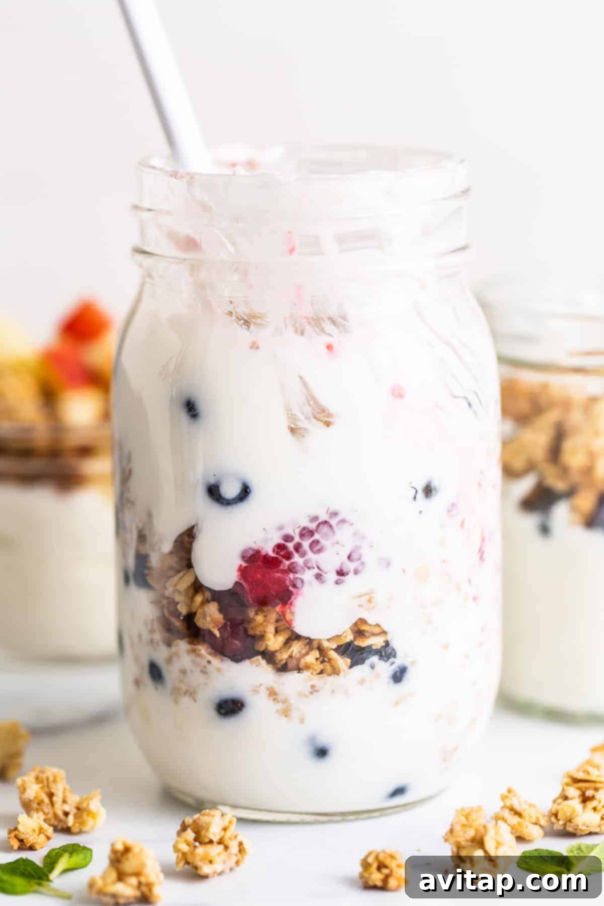 Yogurt parfait in a mason jar filled with fresh berries and granola