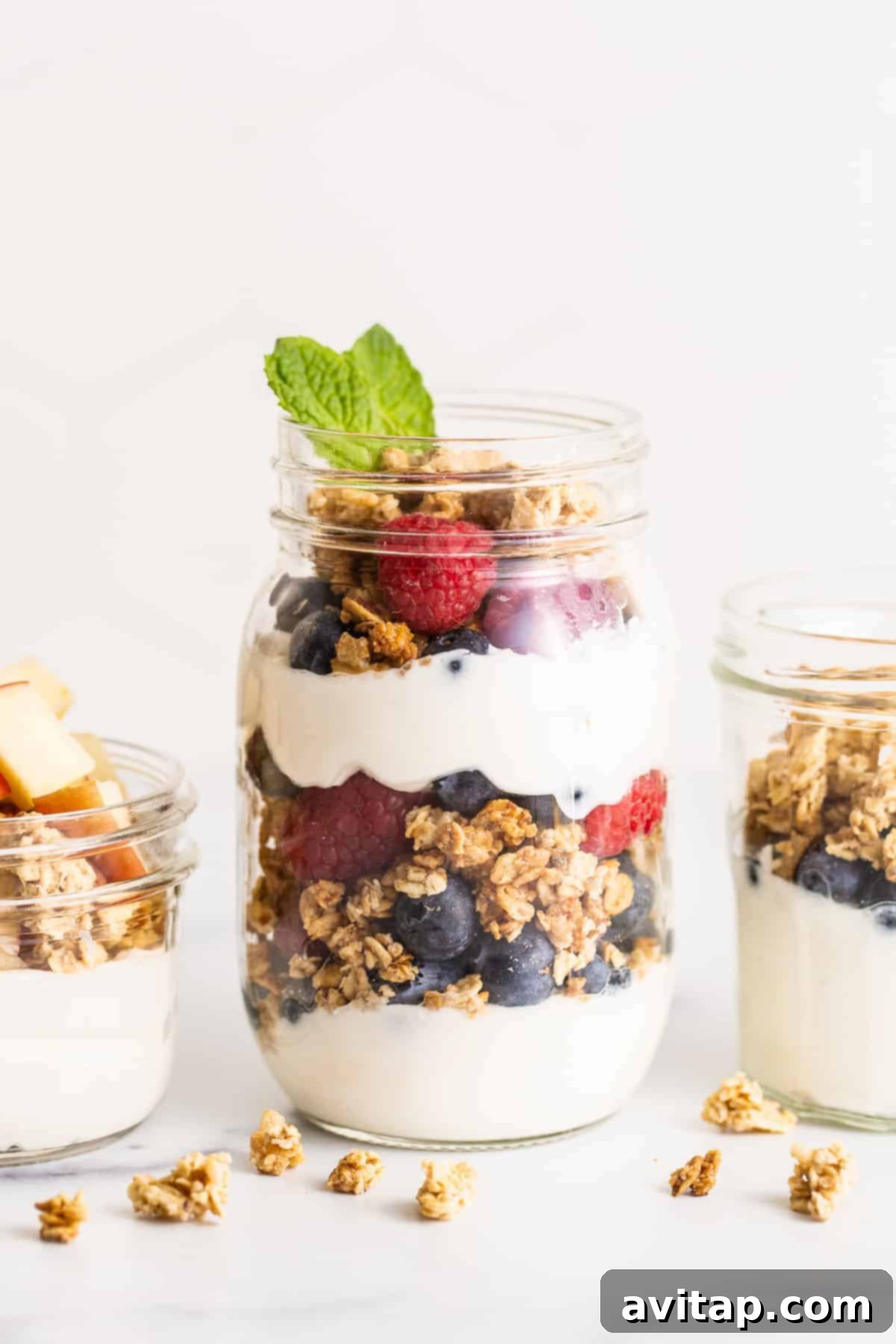 Yogurt parfait in a mason jar, garnished with fresh mint