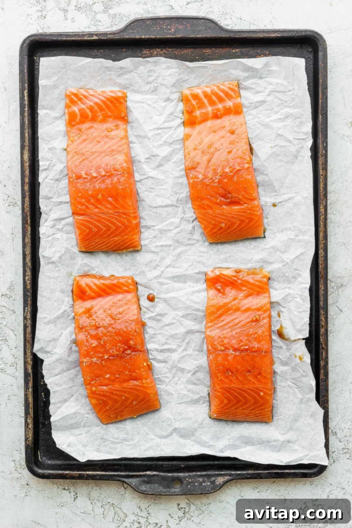 salmon filets on baking sheet