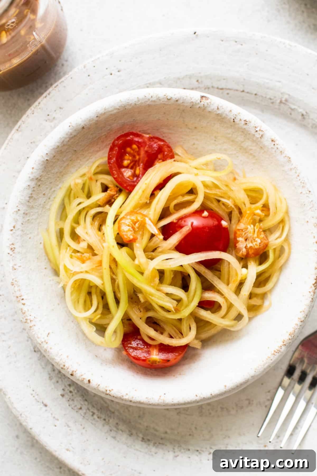 Authentic Green Papaya Salad: Thai & Lao Inspired Recipe A vibrant bowl of Green Papaya Salad, showcasing its fresh ingredients and enticing flavors.
