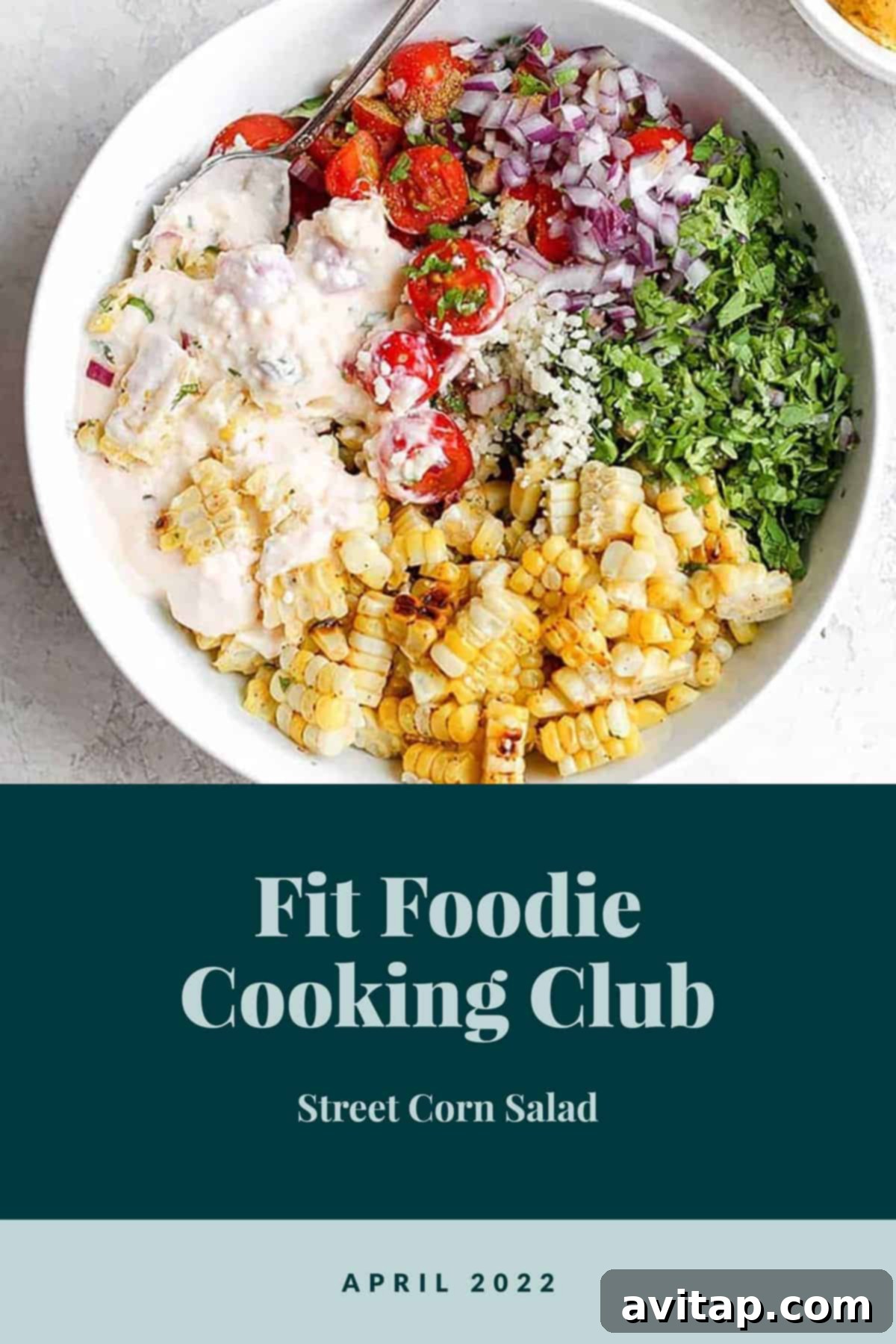 Vibrant Mexican Street Corn Salad in a large serving bowl, garnished with fresh cilantro and lime wedges.