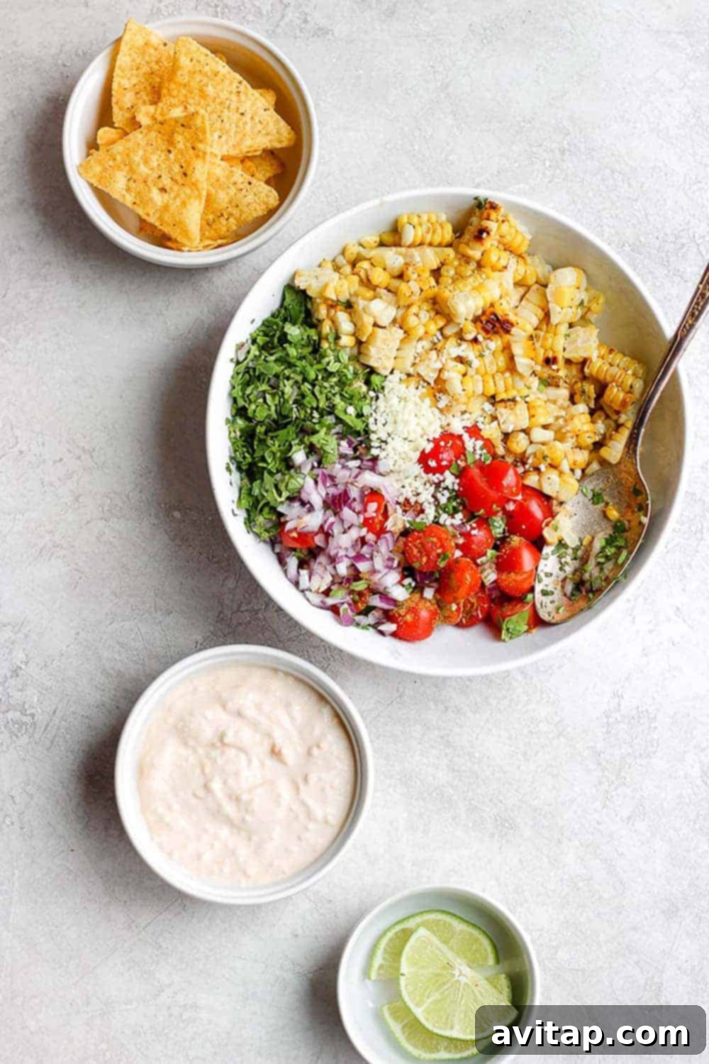 Close up of Mexican Street Corn Salad in a white bowl, showing the texture and ingredients.