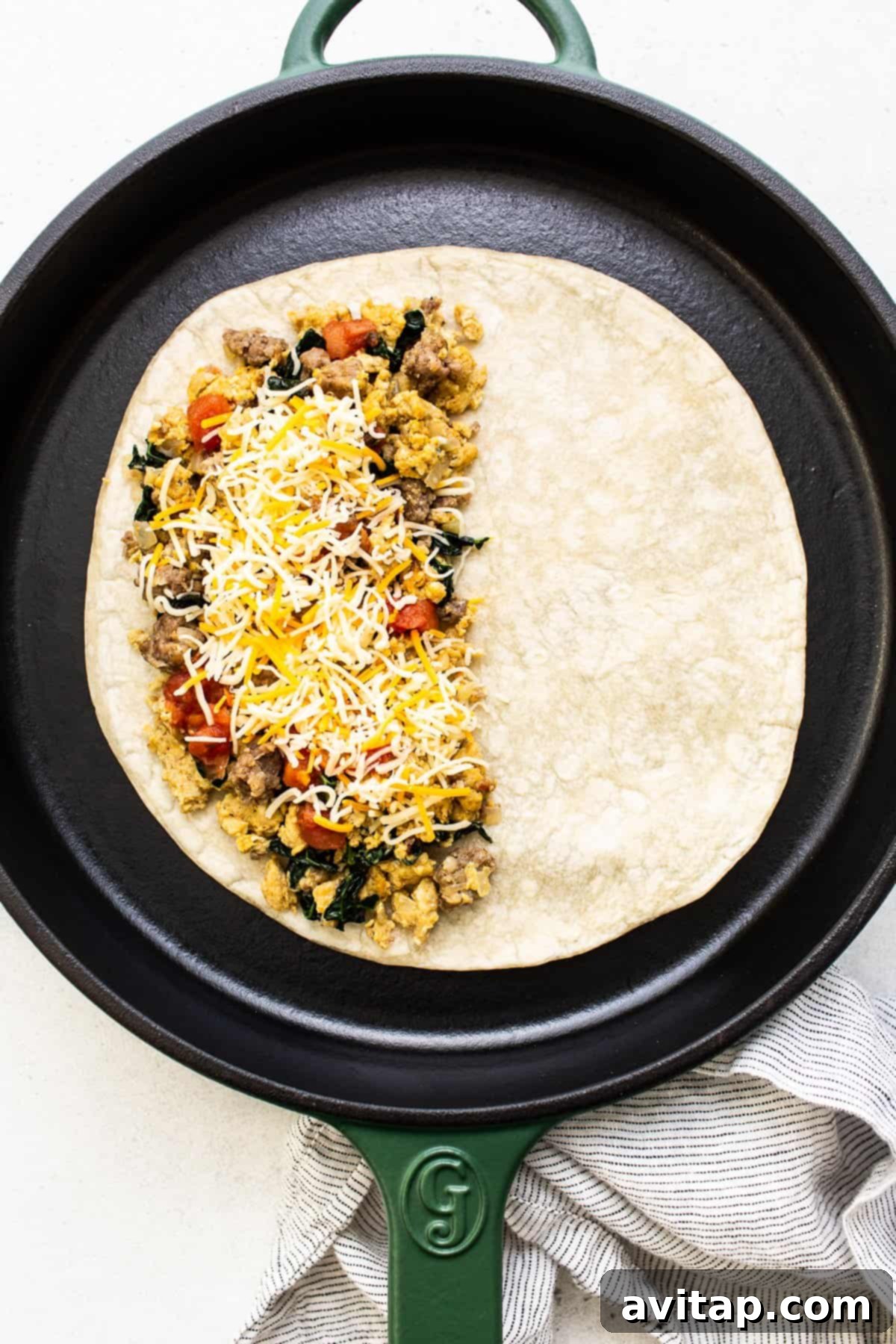 Assembling and cooking a delicious breakfast quesadilla. A golden-brown breakfast quesadilla, perfectly assembled and cooking in a cast iron skillet.