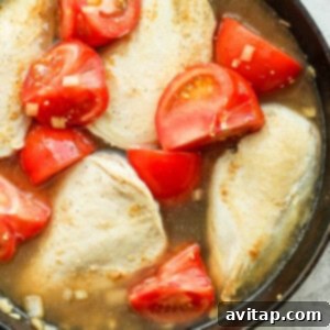 tomatoes and chicken in pan.