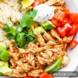 A white bowl with rice and chicken tinga.