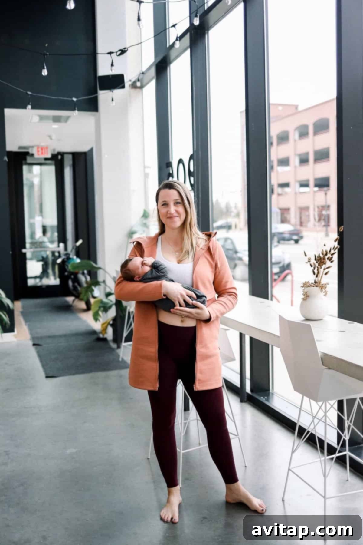 Lululemon Align for Postpartum Woman holding a baby, comfortably dressed in Lululemon Align leggings, perfect for postpartum.