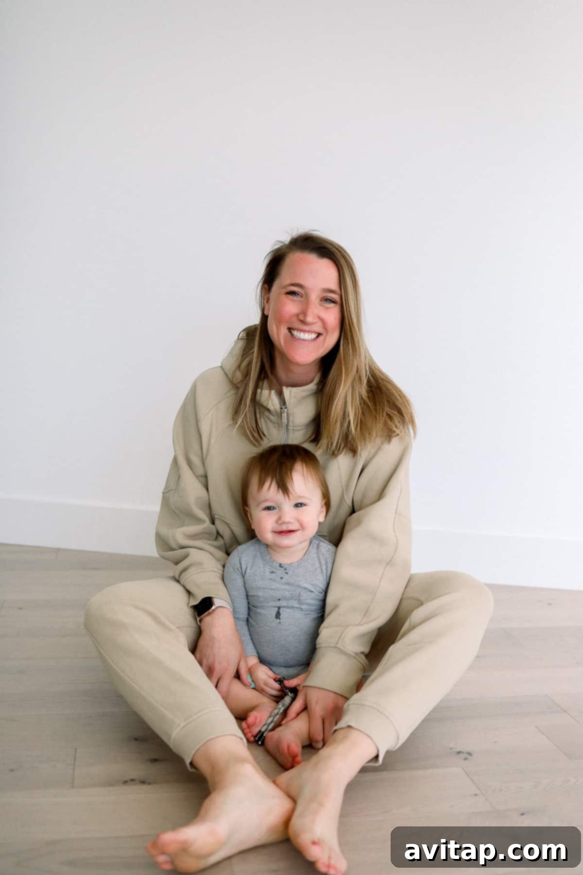 Lululemon Scuba for Postpartum Comfort Woman and baby resting comfortably, the woman wearing a Lululemon Scuba Oversized Half Zip sweatshirt.