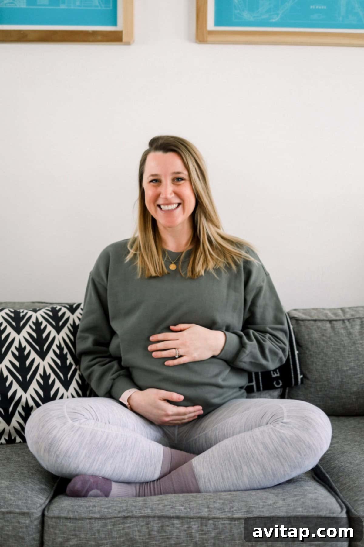 Lululemon Oversized Crew for Pregnancy Pregnant woman relaxing on a couch, wearing a Lululemon Perfectly Oversized Cropped Crew.