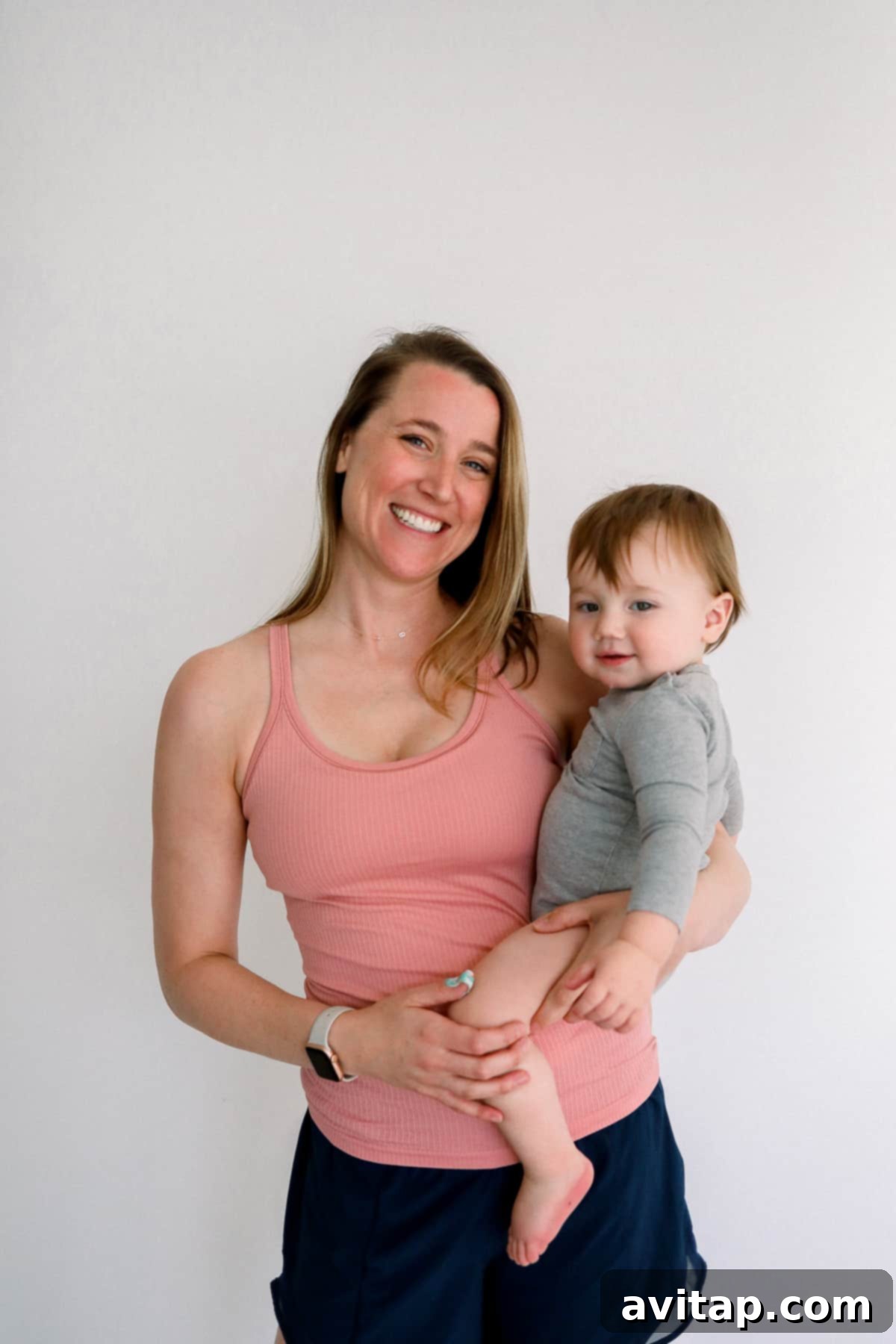 Lululemon Ebb to Street for Nursing Woman holding a baby, wearing a Lululemon Ebb to Street Tank, perfect for nursing mothers.