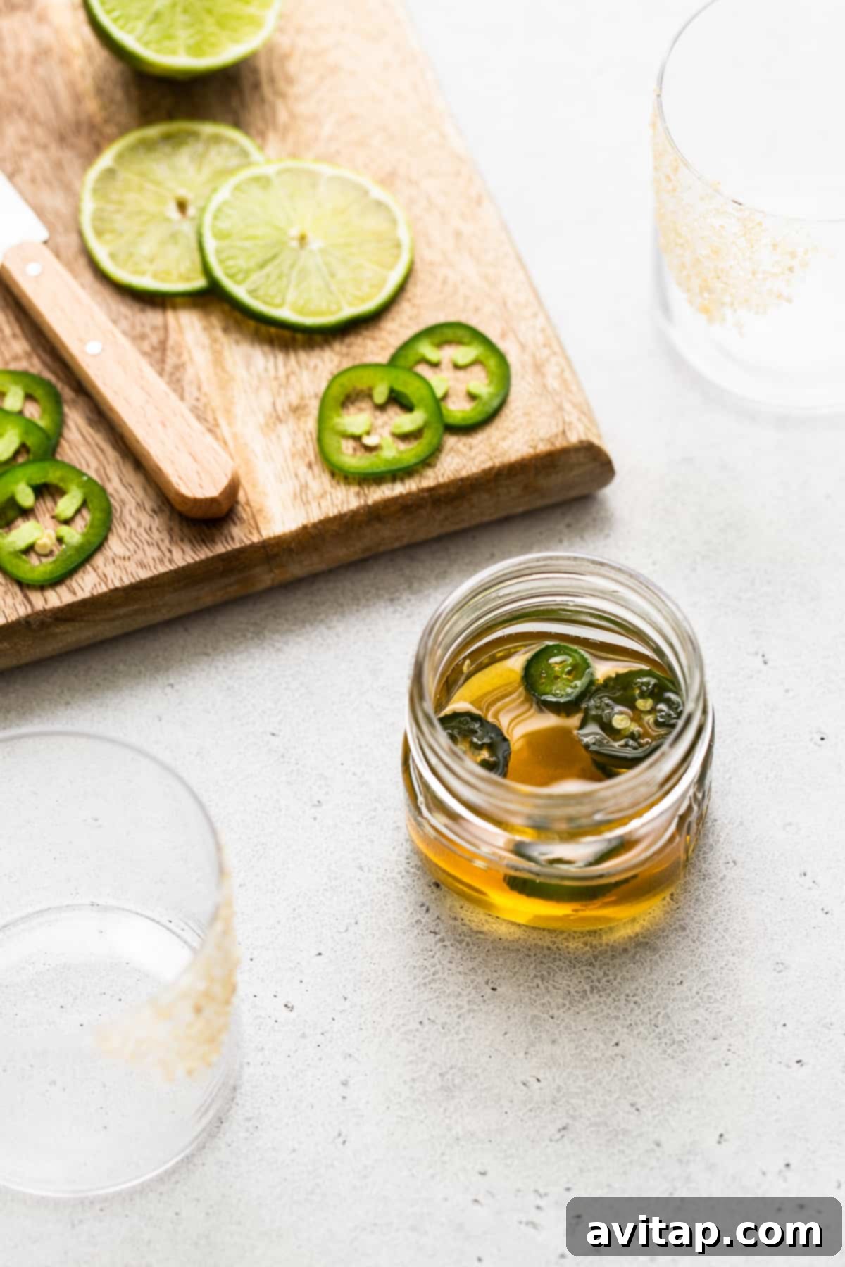 A jar filled with homemade spicy agave simple syrup, showcasing its rich texture.