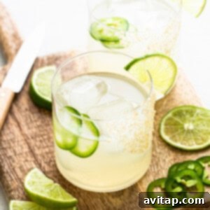 A perfectly crafted spicy mezcal margarita, garnished with lime and jalapeño.
