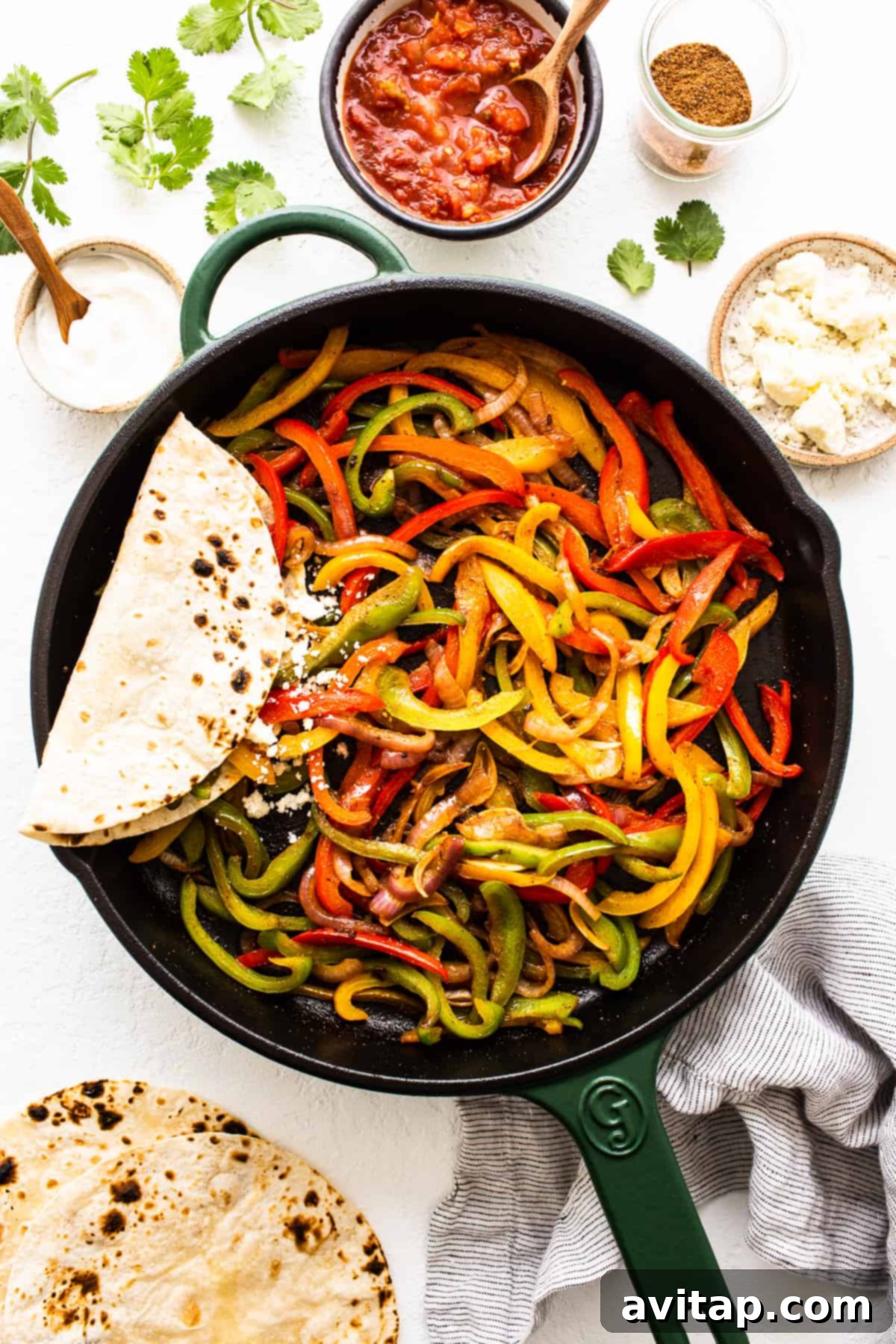 Vibrant fajita veggies perfectly cooked in a cast iron pan, ready to serve.