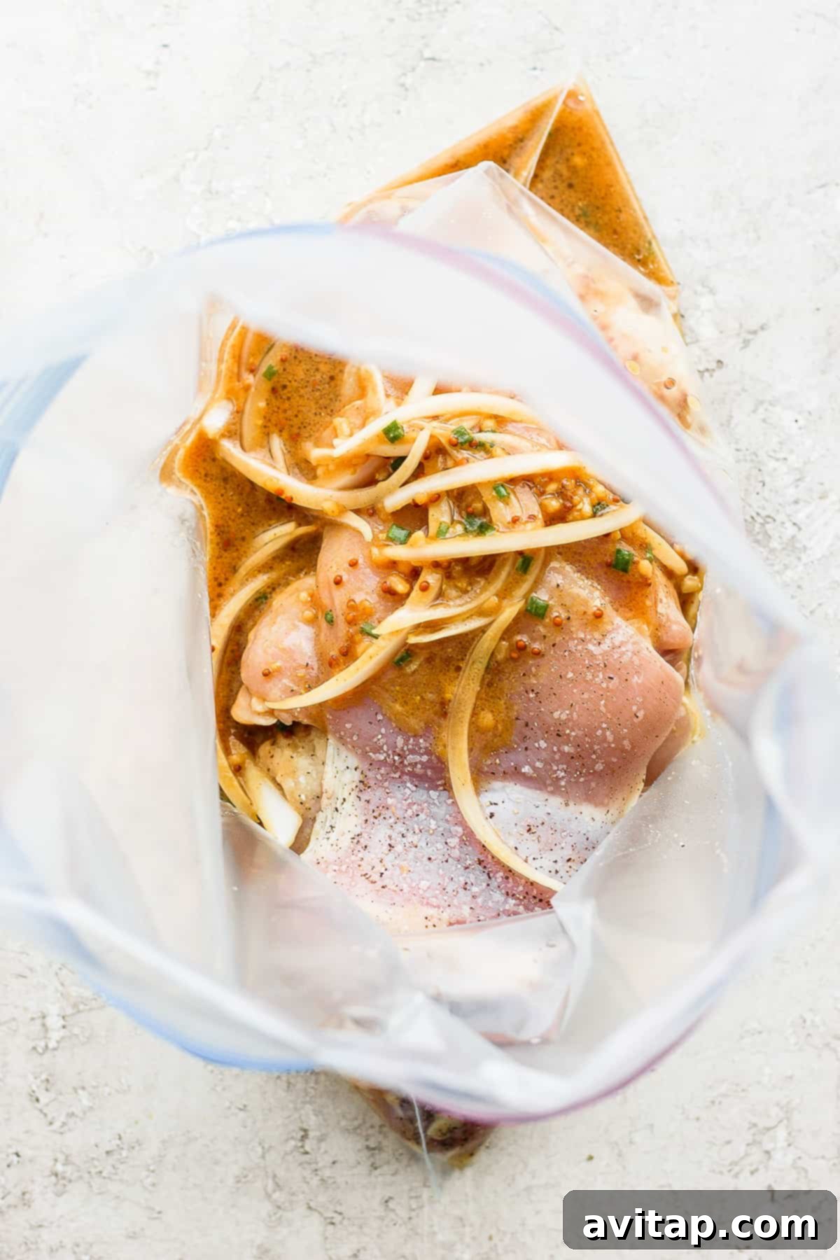 marinating chicken in sauce.