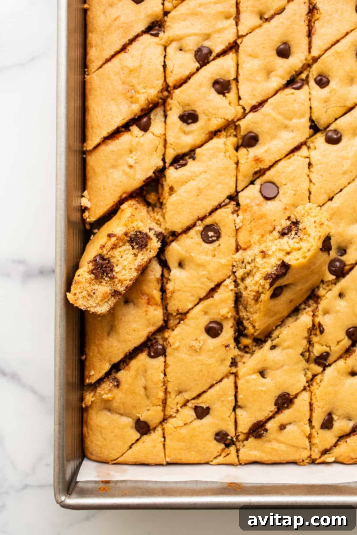 Maple-Infused Chocolate Chip Blondie Bars 2 Golden brown maple chocolate chip cookie blondie bars arranged neatly in a glass baking dish, ready for serving.