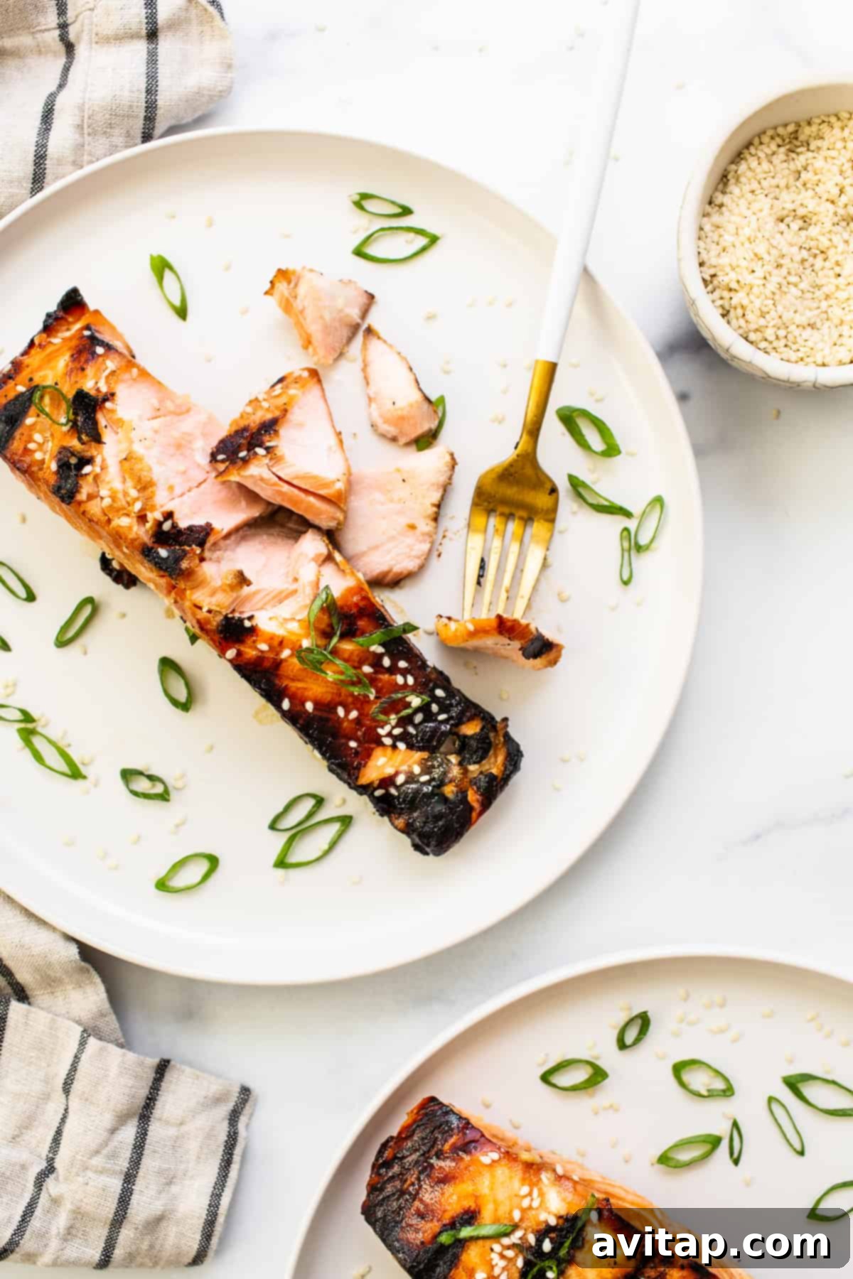 flakey salmon with fork on plate.