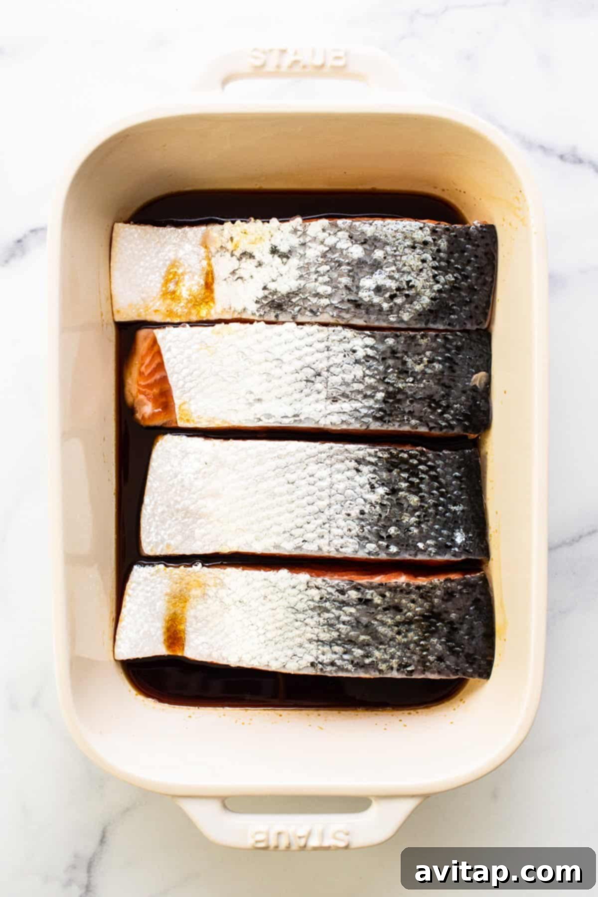 salmon marinating in dish.
