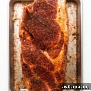 Tender Smoked Pork Shoulder 11 Pork shoulder generously sprinkled with dry rub, ready for chilling and flavor absorption.