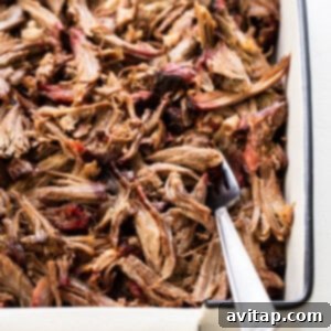 Tender Smoked Pork Shoulder 13 Shredded smoked pork shoulder in a tray, with its rich, smoky color, ready to be enjoyed or served.