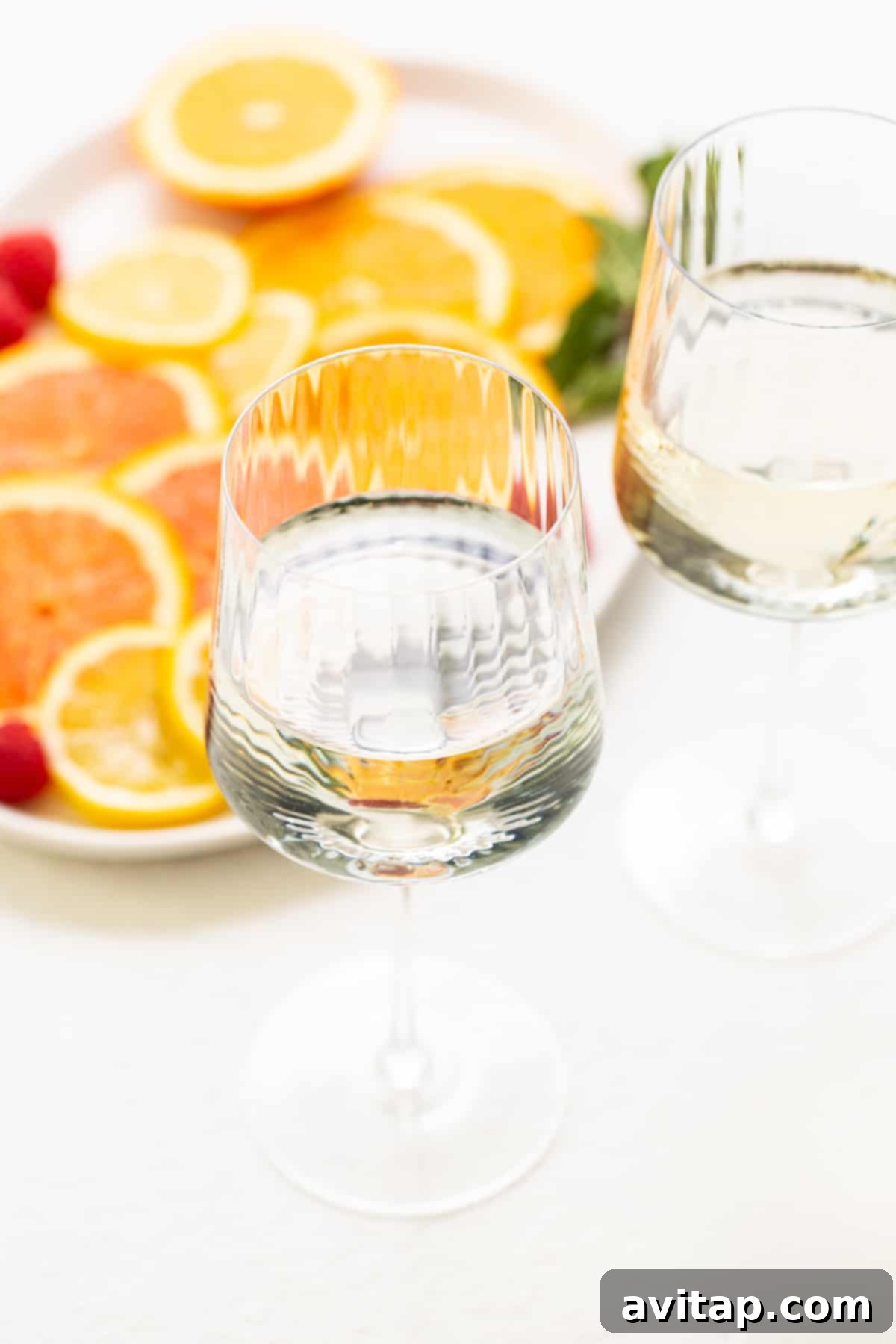 A crisp white wine in a glass, ready to be transformed into a refreshing spritzer.