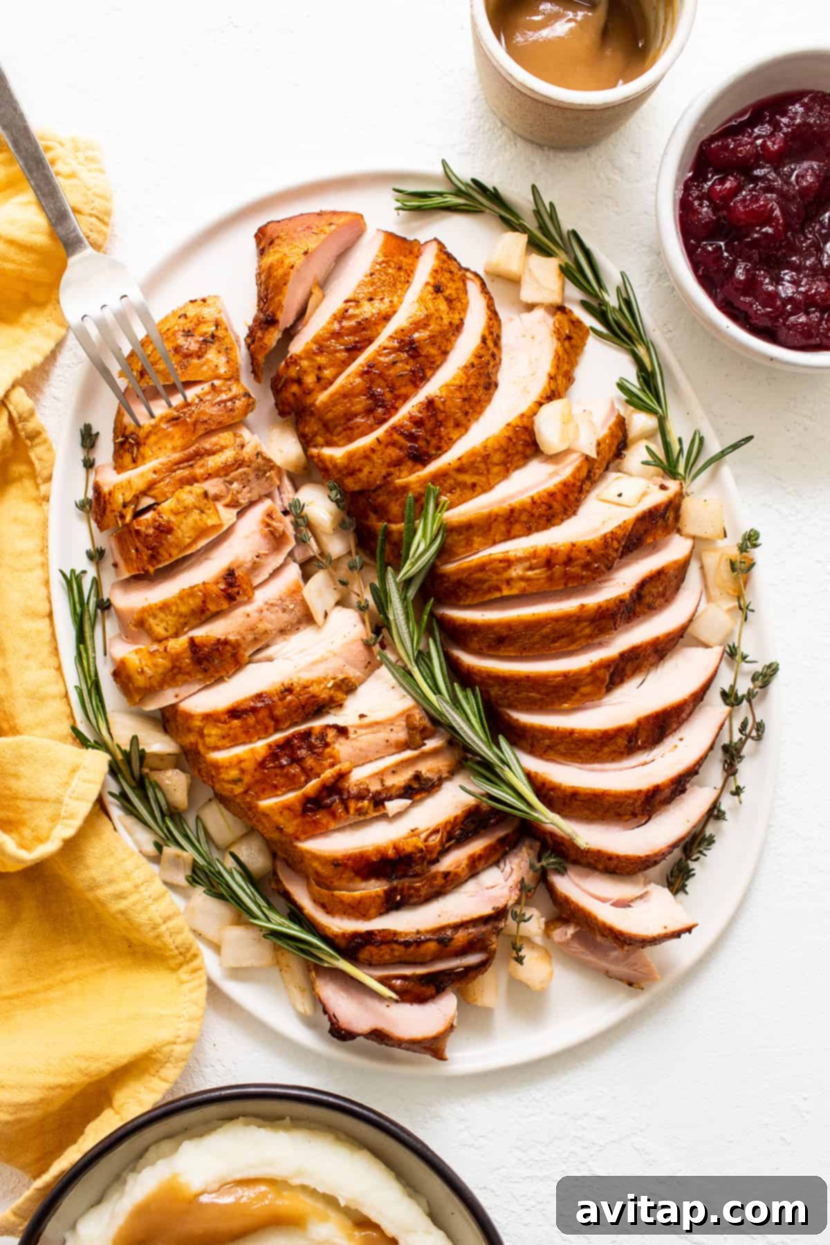 Perfectly sliced smoked turkey breast arranged on a plate, ready to be served. 