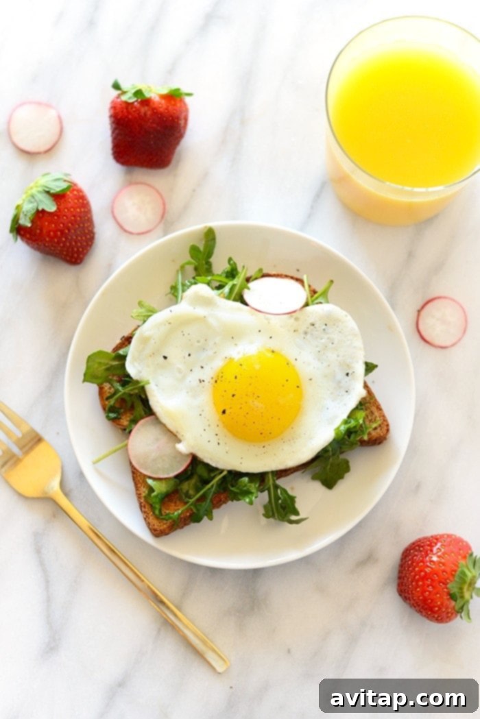 Toast Tuesday Egg and Arugula Special 6 Vertical close-up of Egg and Arugula Toast, highlighting texture and freshness